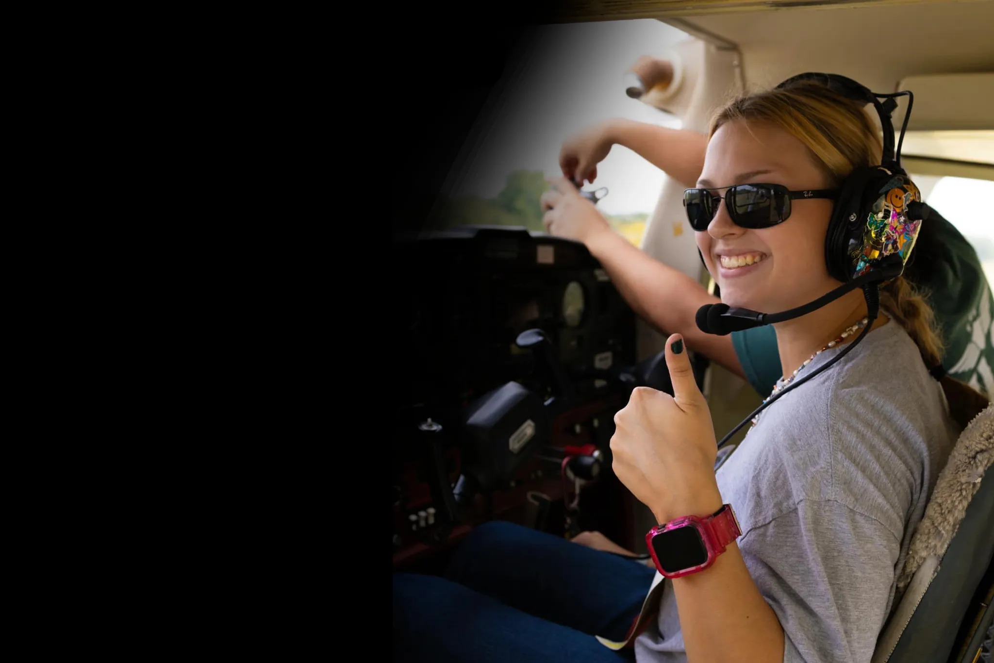 Pilot giving thumbs up inside airplane cockpit at Alto Pilot Flight School in Oklahoma City