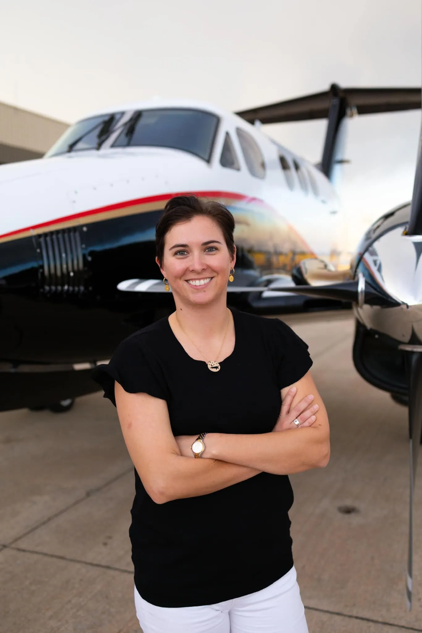 Female pilot in front of a king air airplane