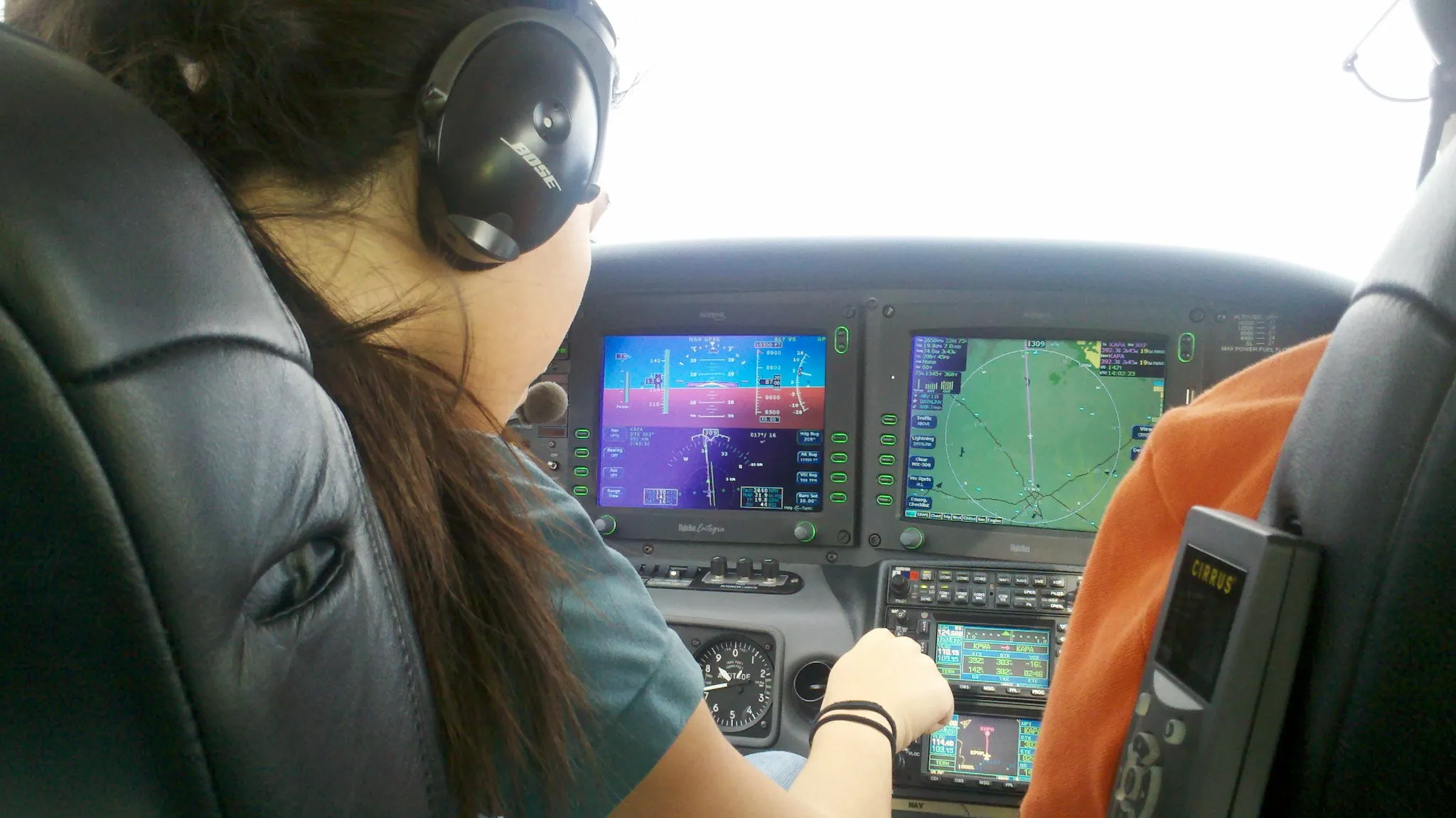 pilot in a cirrus sr22 airplane programming garmin 430