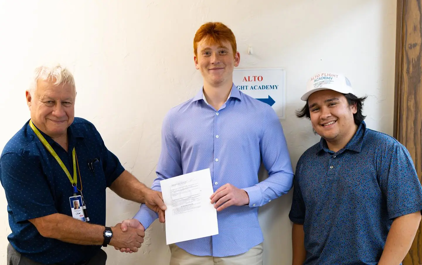 New pilot standing with aircraft after passing checkride