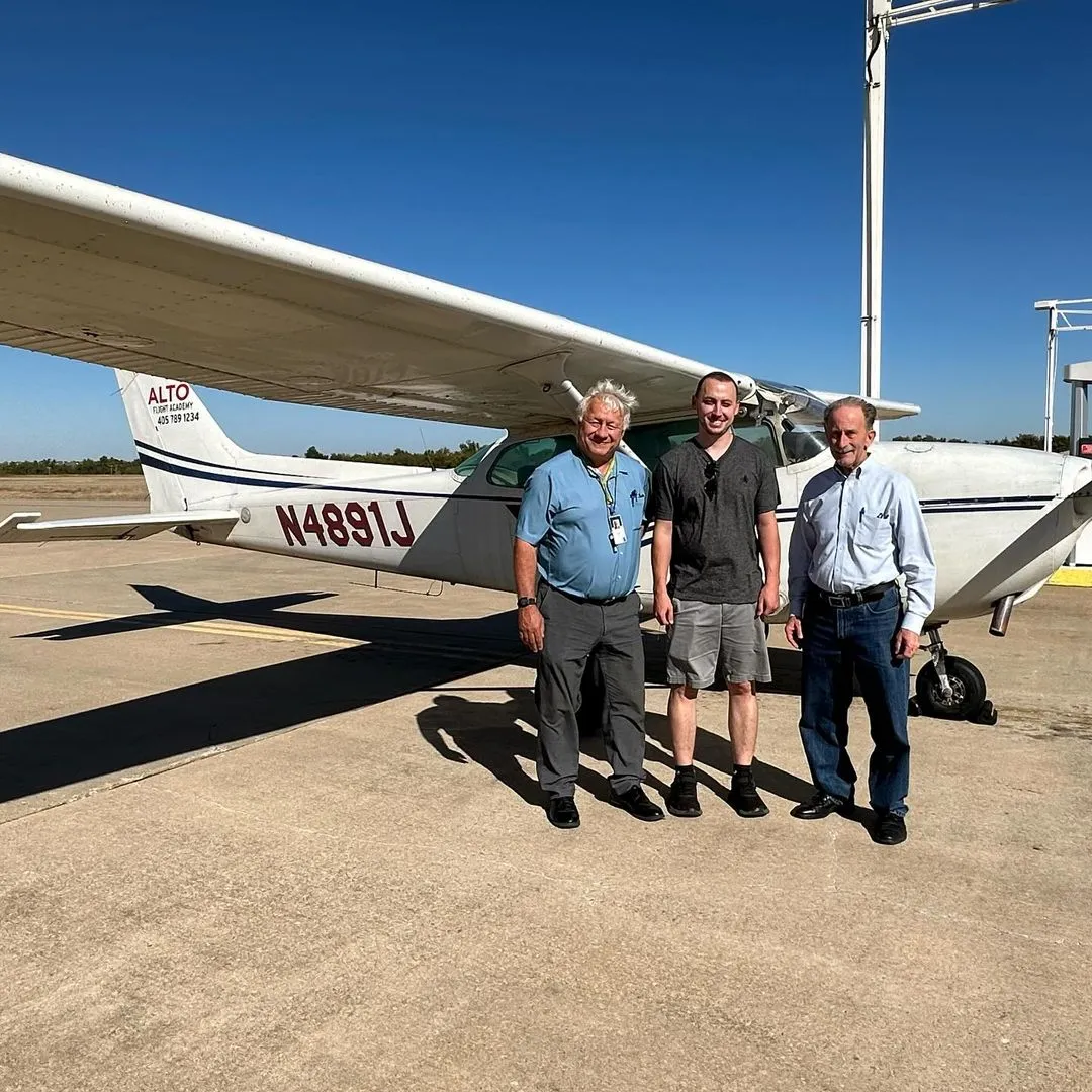 Student pilot in front of a cessna 172 in Yukon, OK after private pilot checkride