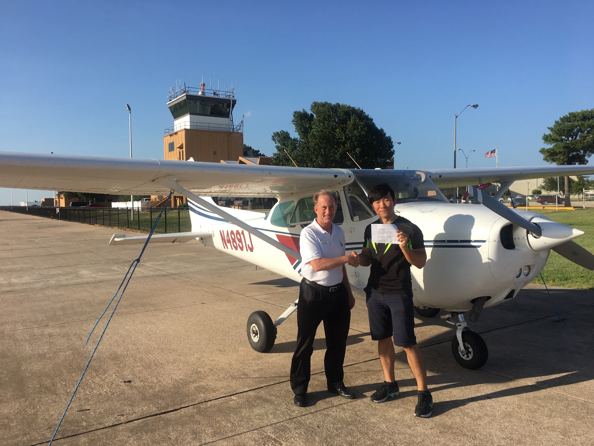 Student with Private Pilot License (PPL) with Instructor in front of a Cessna 172 at Sundance Airport
